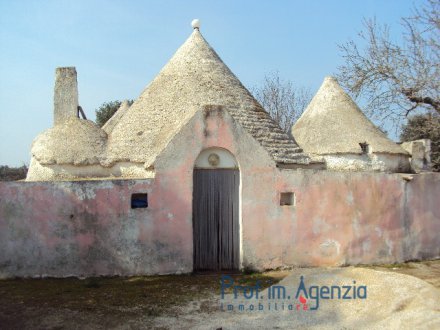 Enchanting comlex of trulli with six cones and lamia on a very interesting land
